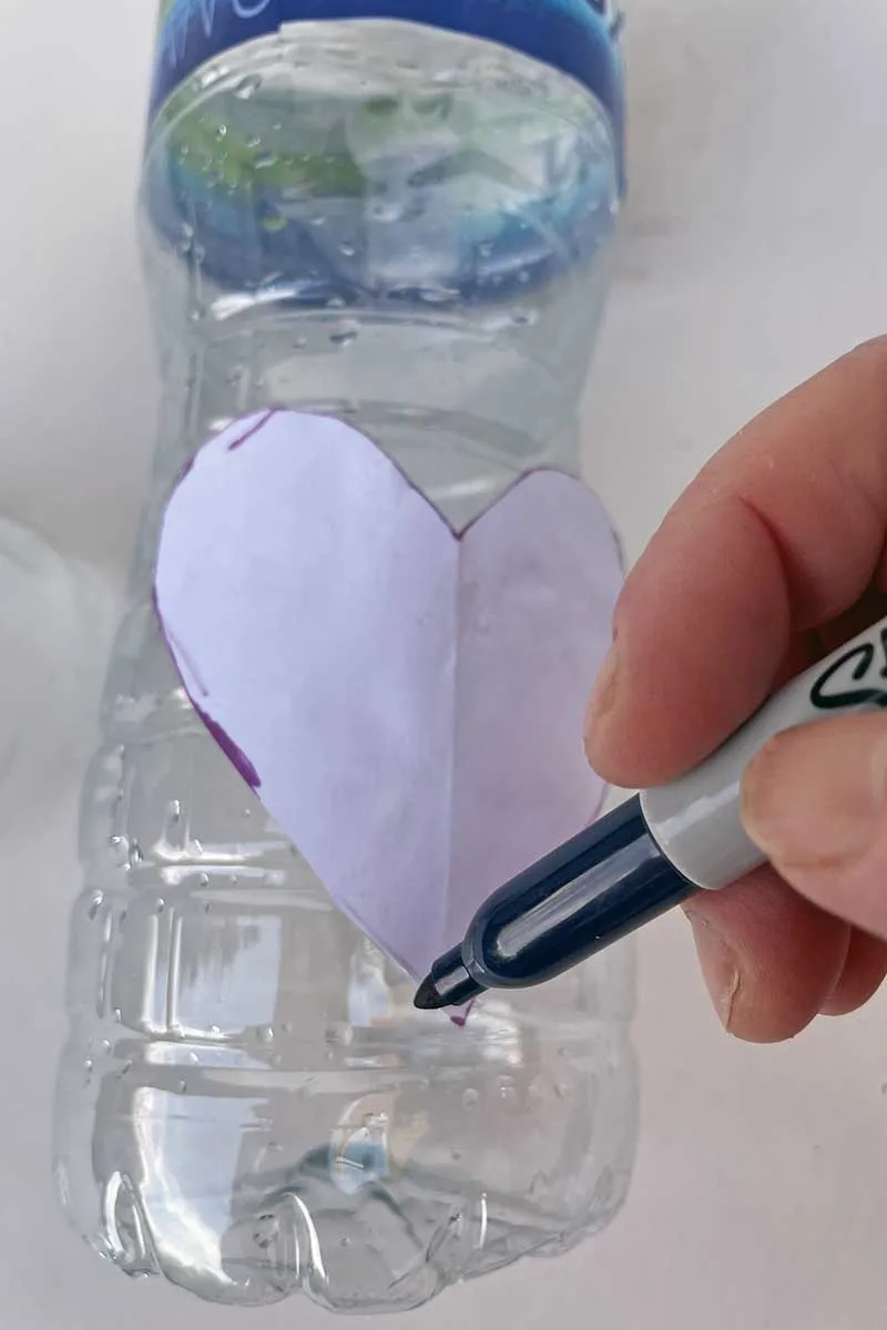 drawing heart shape on plastic bottle with a sharpie