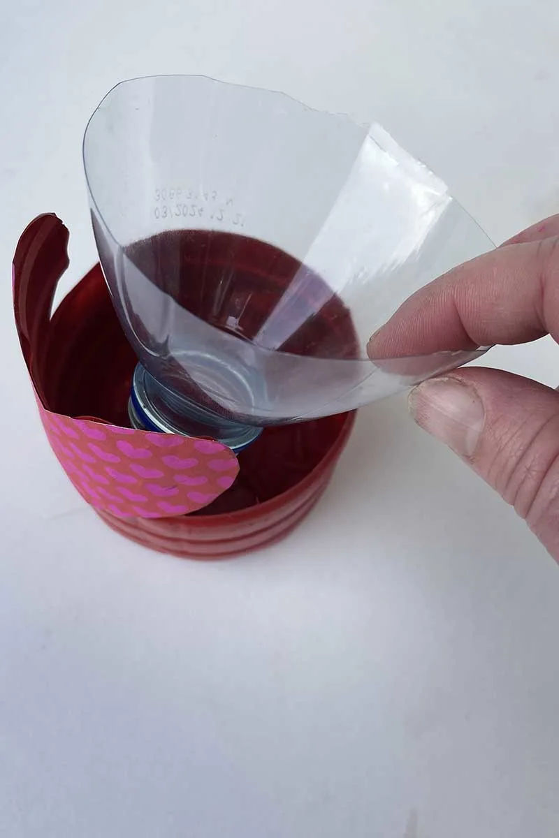 Putting the bottle top upside down in the planter