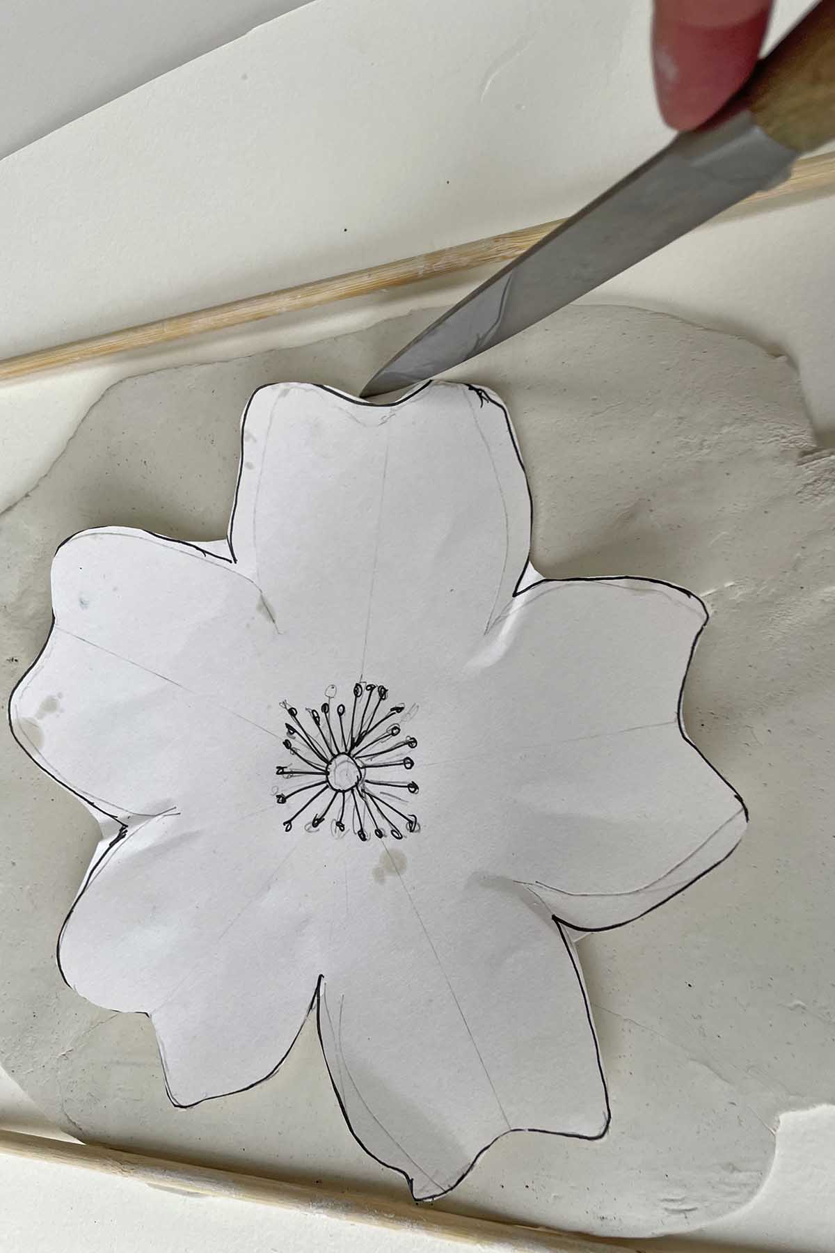 Cutting out the floral shape with the clay