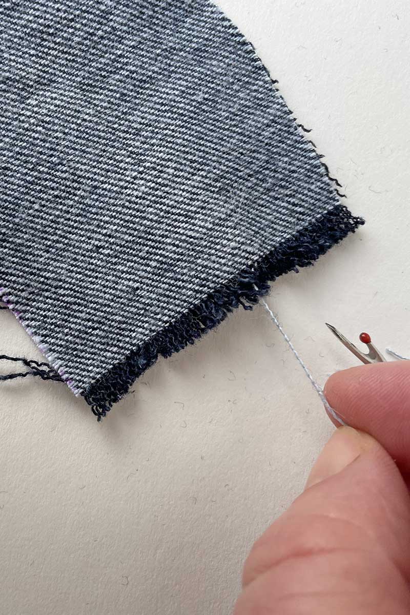 pulling threads to fray denim