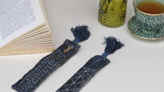 Pair of denim bookmarks with Sashiko stitching book and cup of tea