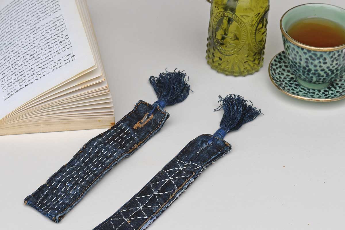 Pair of denim bookmarks with Sashiko stitching book and cup of tea