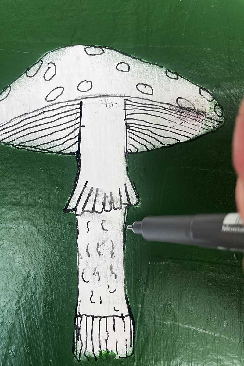 Drawing mushroom motif onto paper mache tray