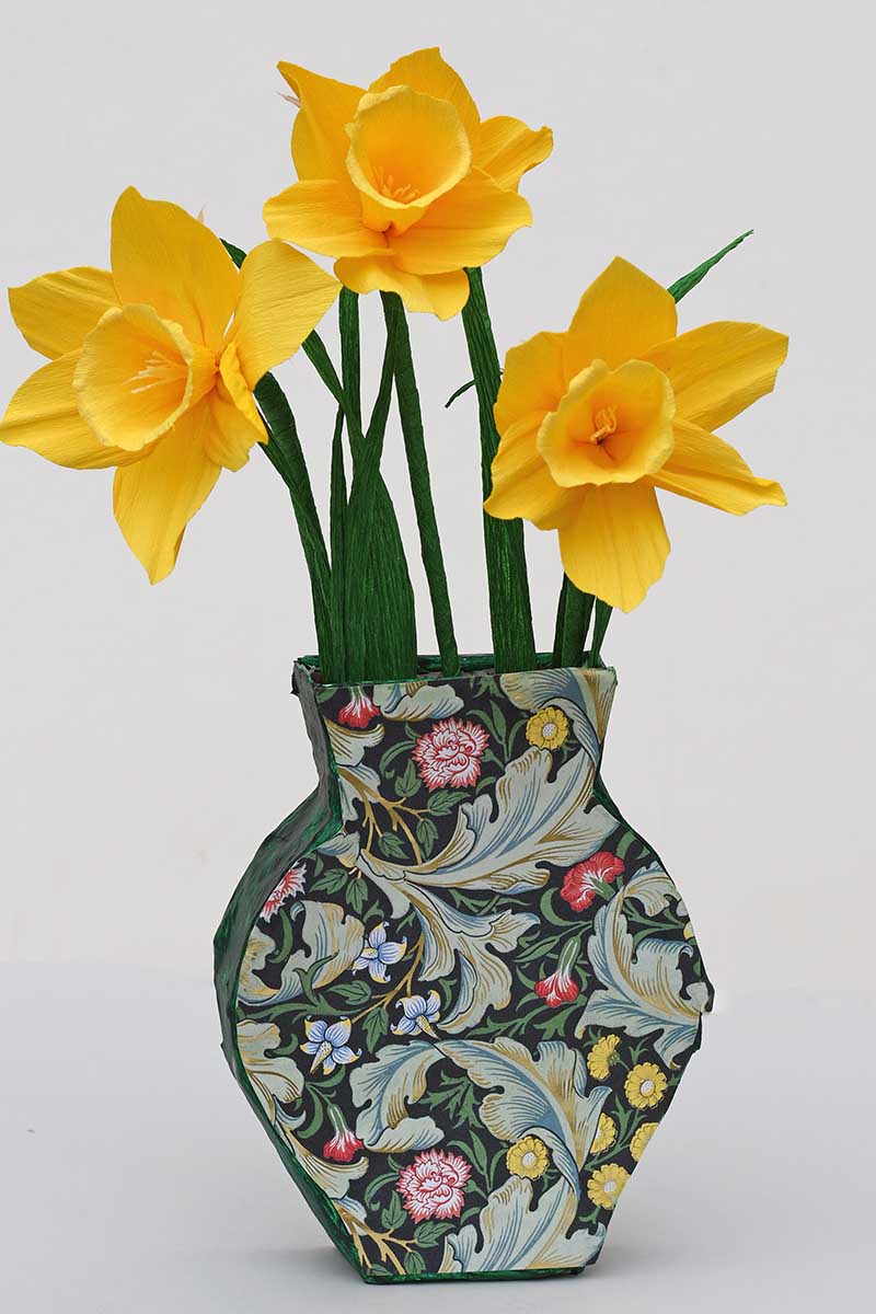 Green paper mache vase with paper daffodils