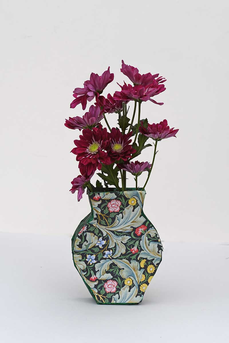 Green paper mache vase with real flowers