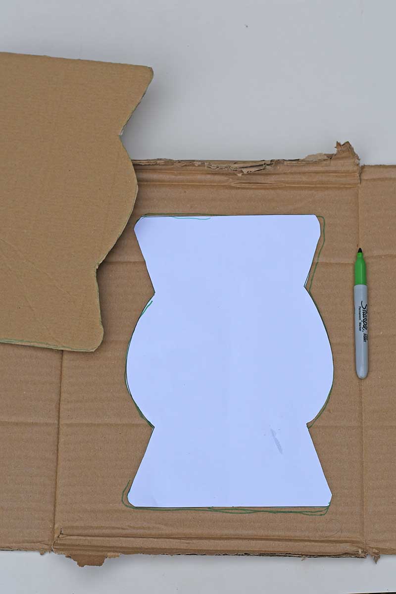 drawing around the vase template on cardboard and cutting it out