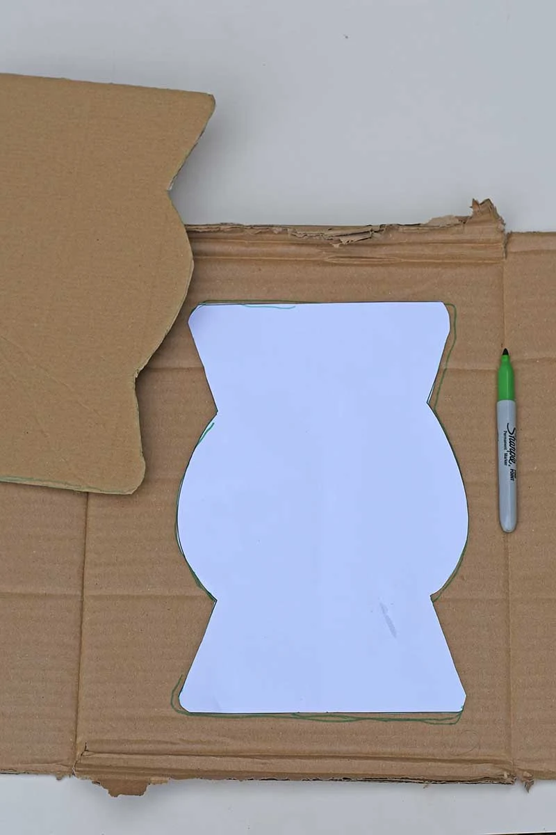 drawing around the vase template on cardboard and cutting it out