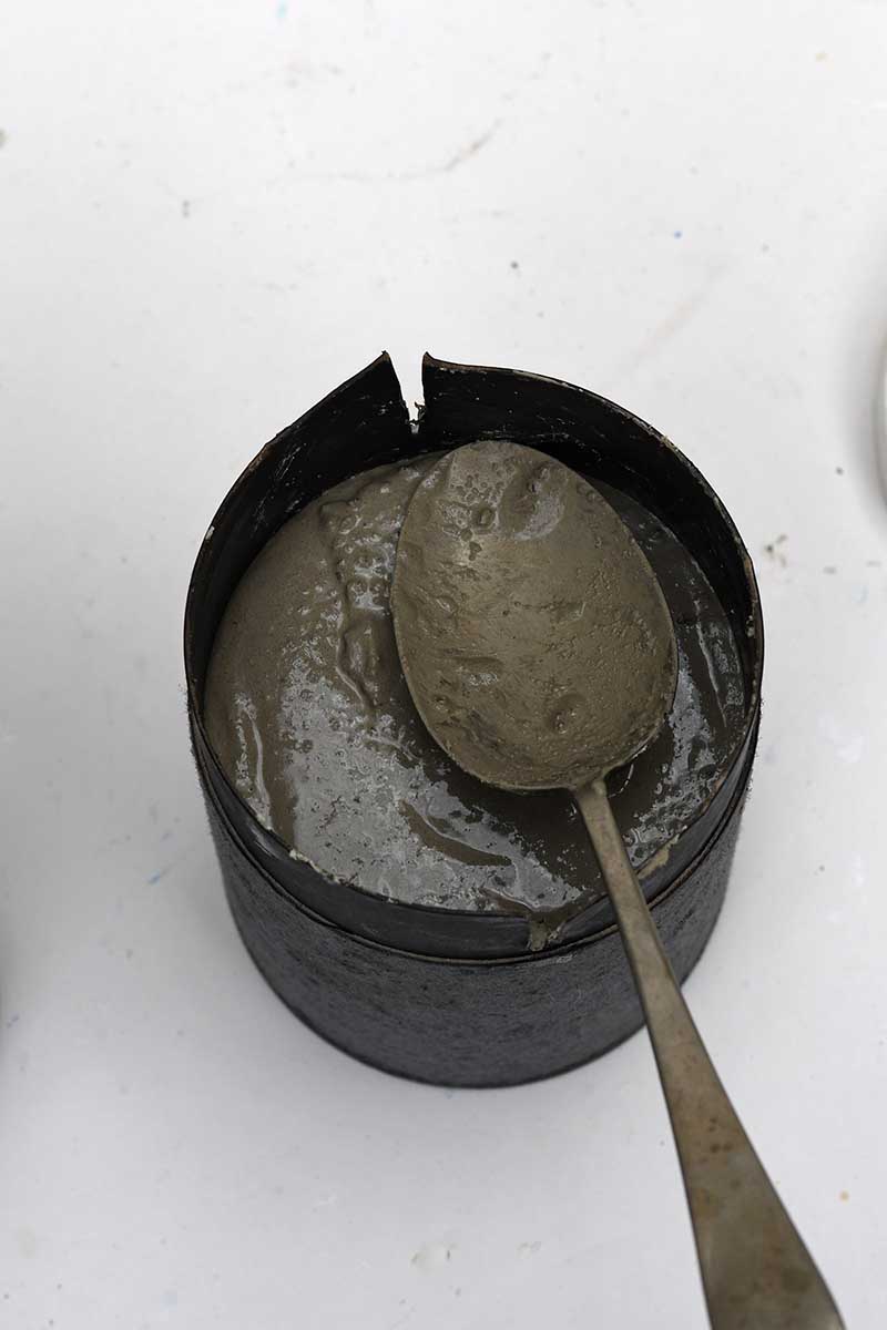spooning concrete mixture into moulds