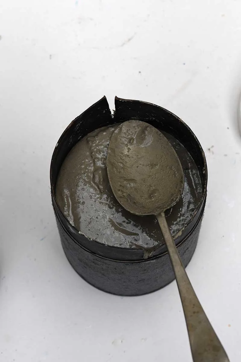 spooning concrete mixture into moulds