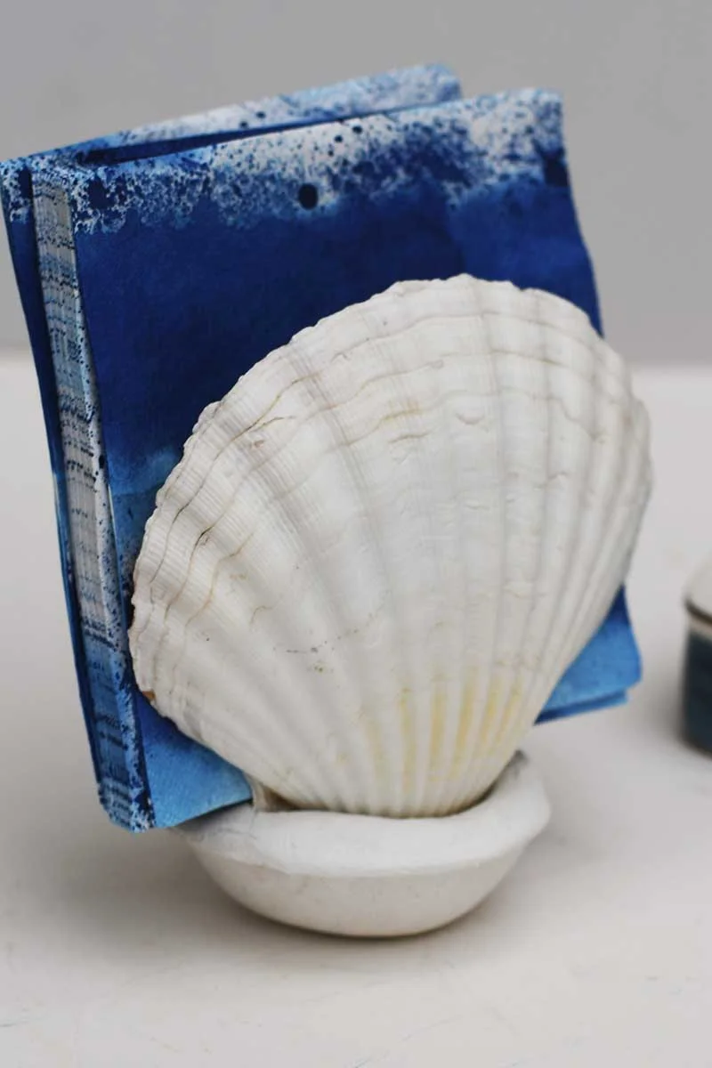 Napkins in scallop shell napkin holder