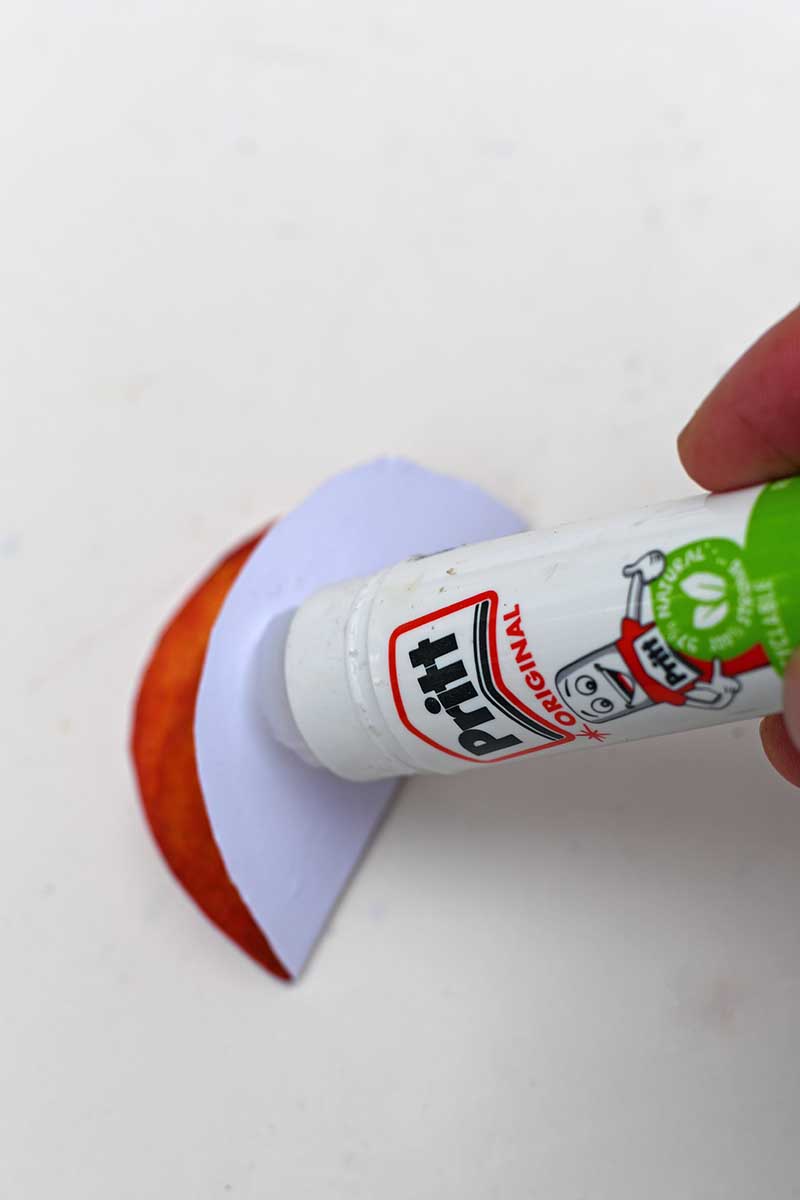 adding glue to paper with glue stick