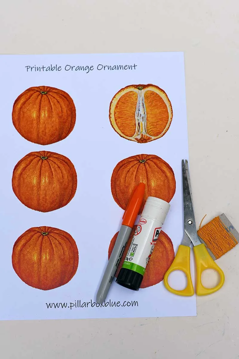 orange paper fruit ornament template scissors sharpies and glue stick