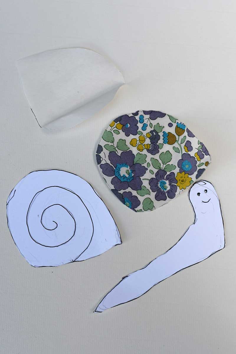 Snail template with fabric applieque piece for shell and interfacing for the shell.