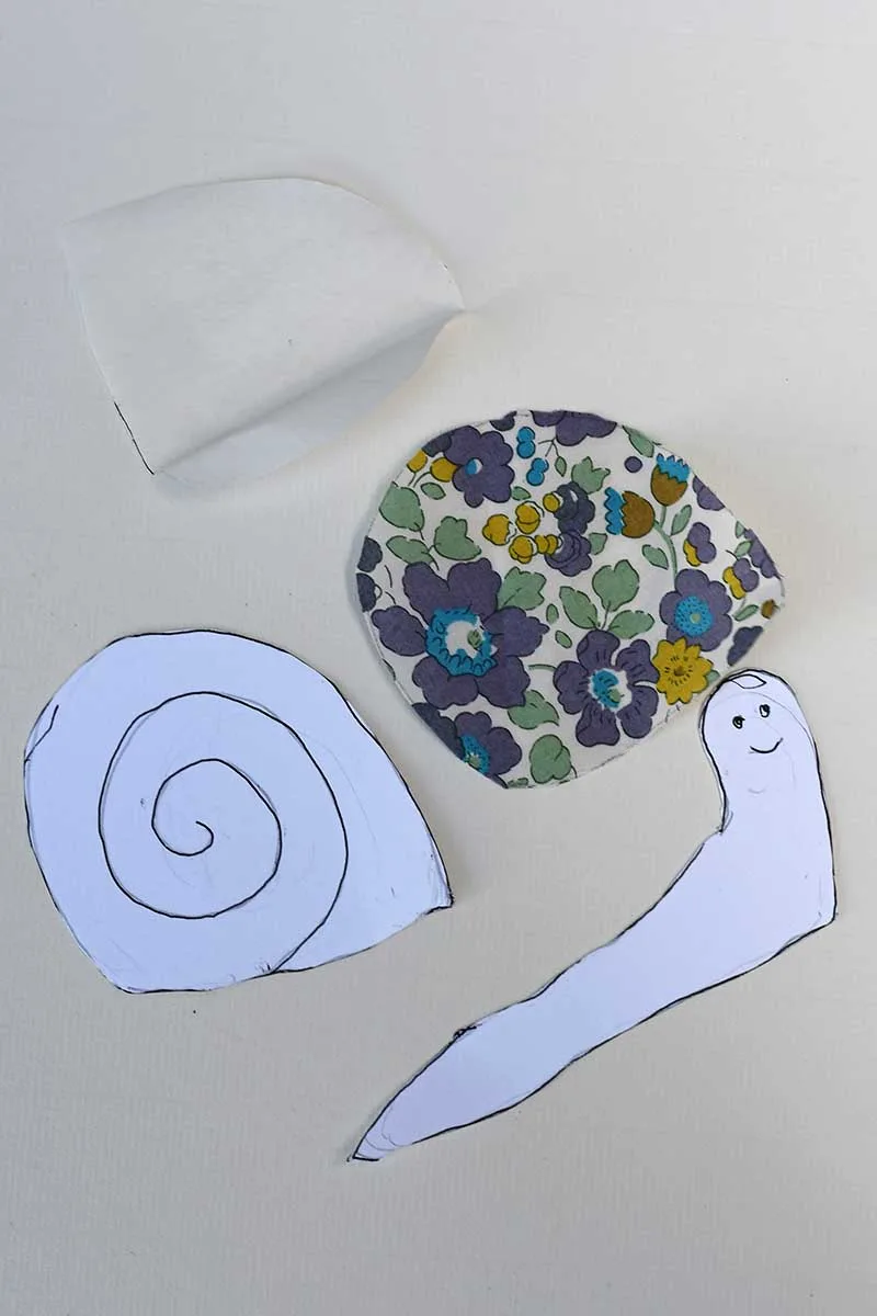 Snail template with fabric applieque piece for shell and interfacing for the shell.