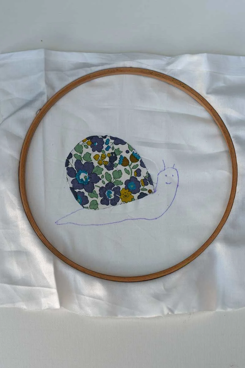 snail with applique shell in hoop ready for  free motion embroidery 