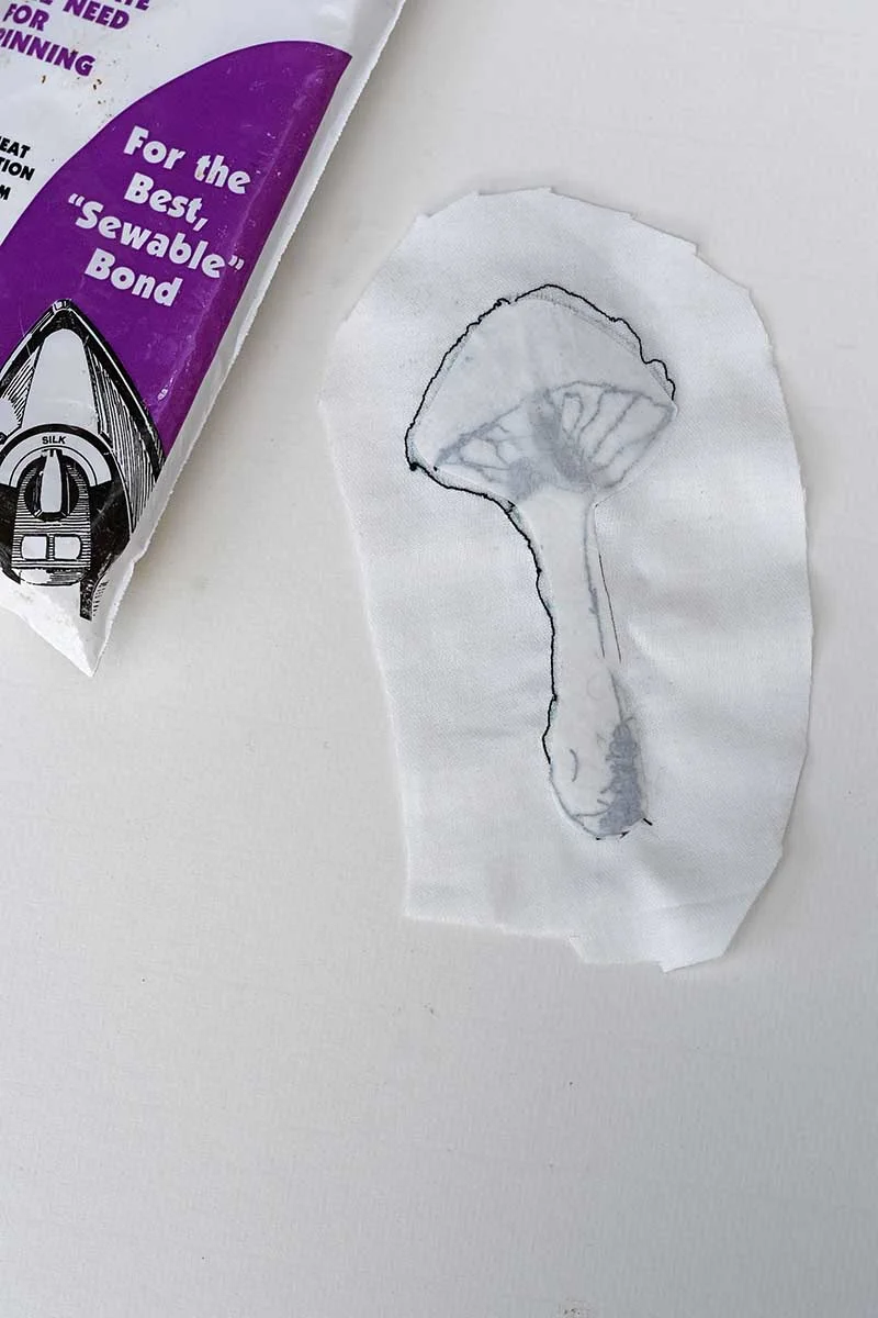 Adding bonding web to the back of the motion embroidered mushroom