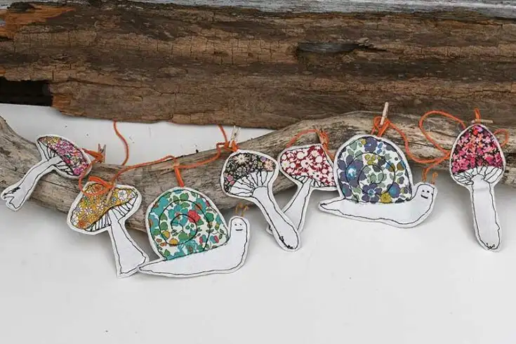 free motion embroidery garland of scrap fabric applique mushrooms and snails