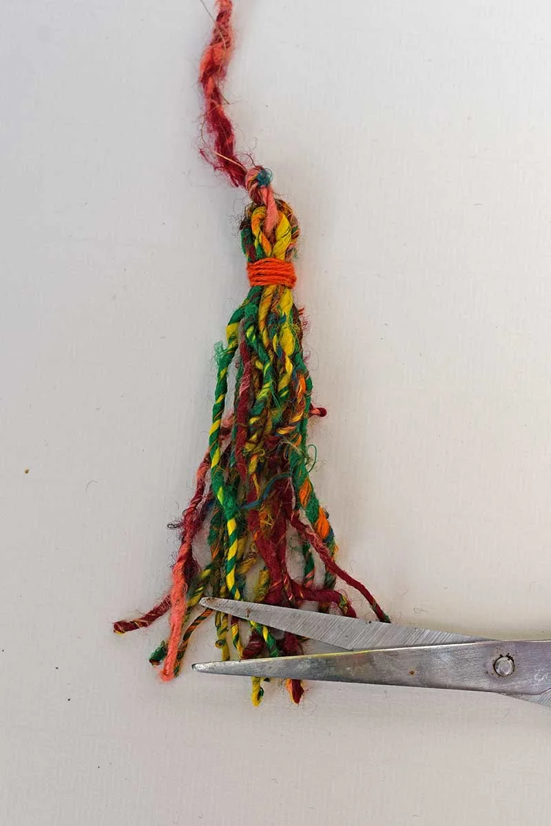 making a Halloween tassel for upcycled tin can door hangers