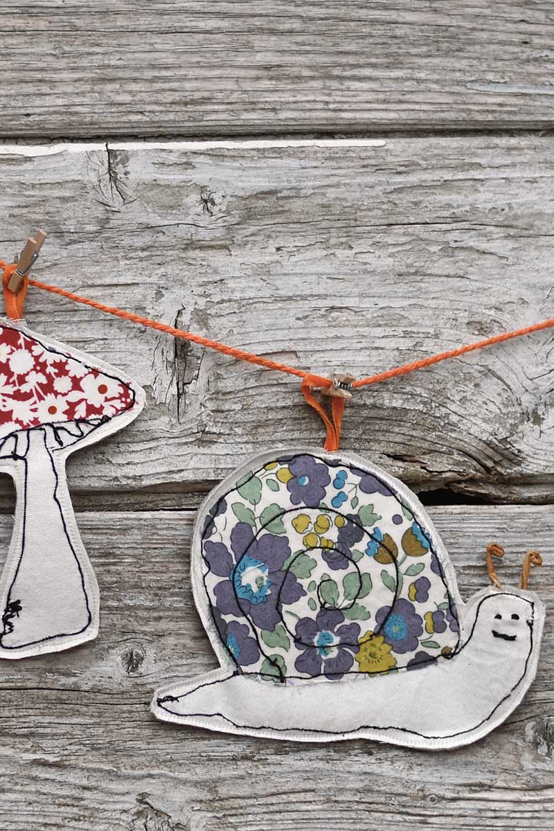 scrap fabric fee motion embroidery snail and mushroom hanging on a garland