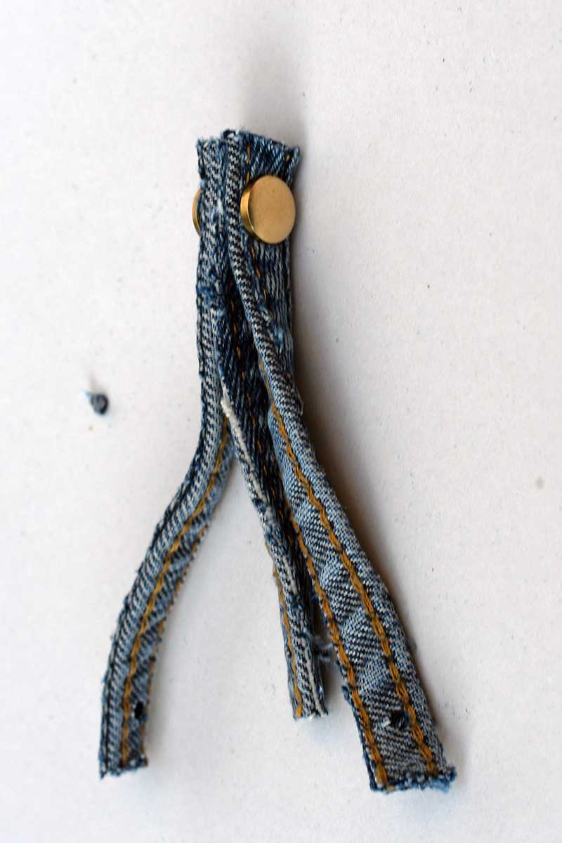 Adding first Chicago screws into denim seam ornaments