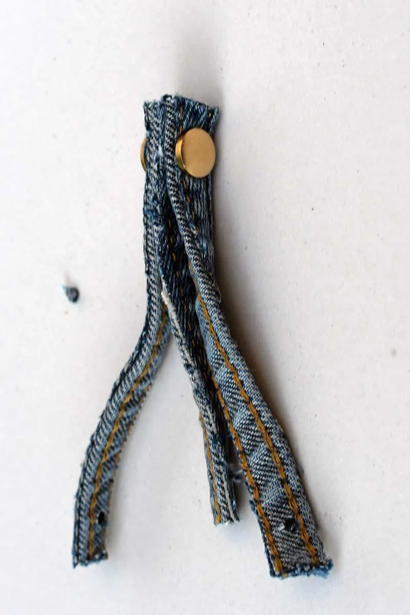 Adding first Chicago screws into denim seam ornaments
