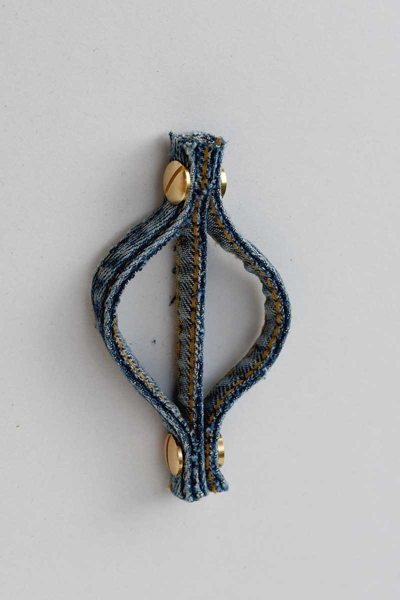 adding the second Chicago screws to the bottom denim seam ornament