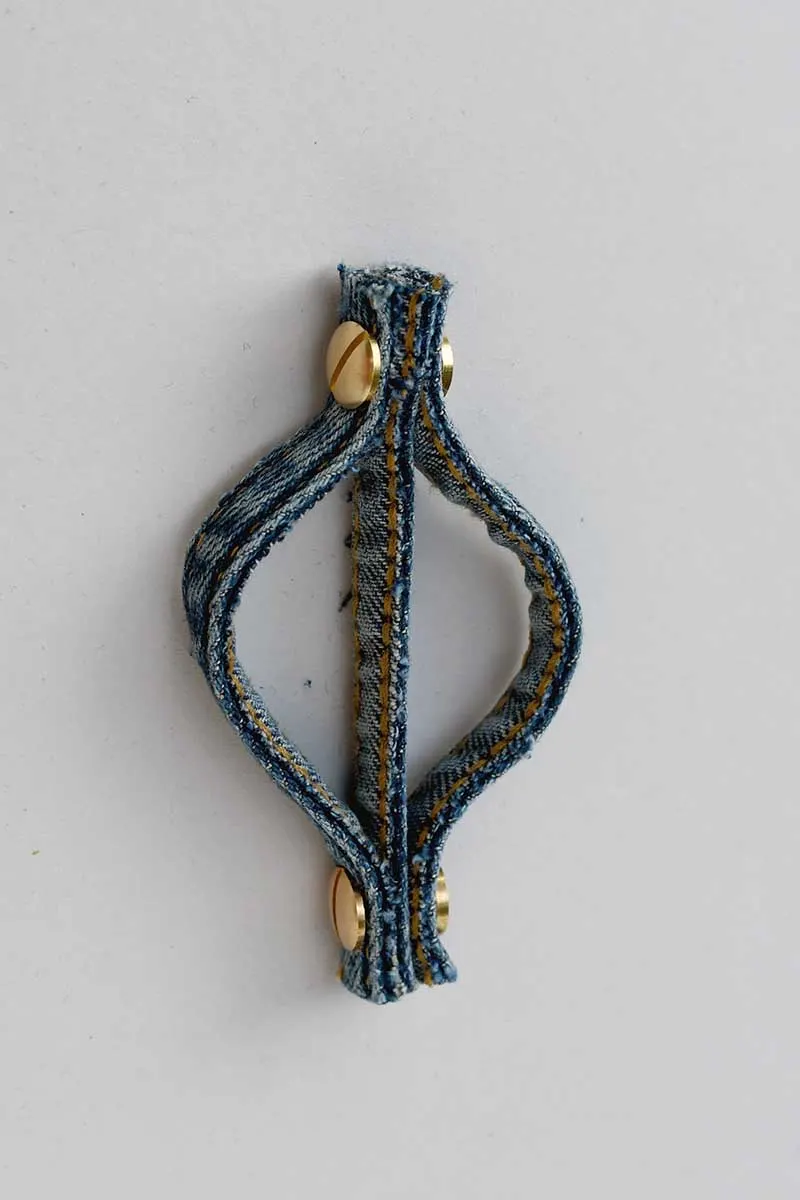 adding the second Chicago screws to the bottom denim seam ornament