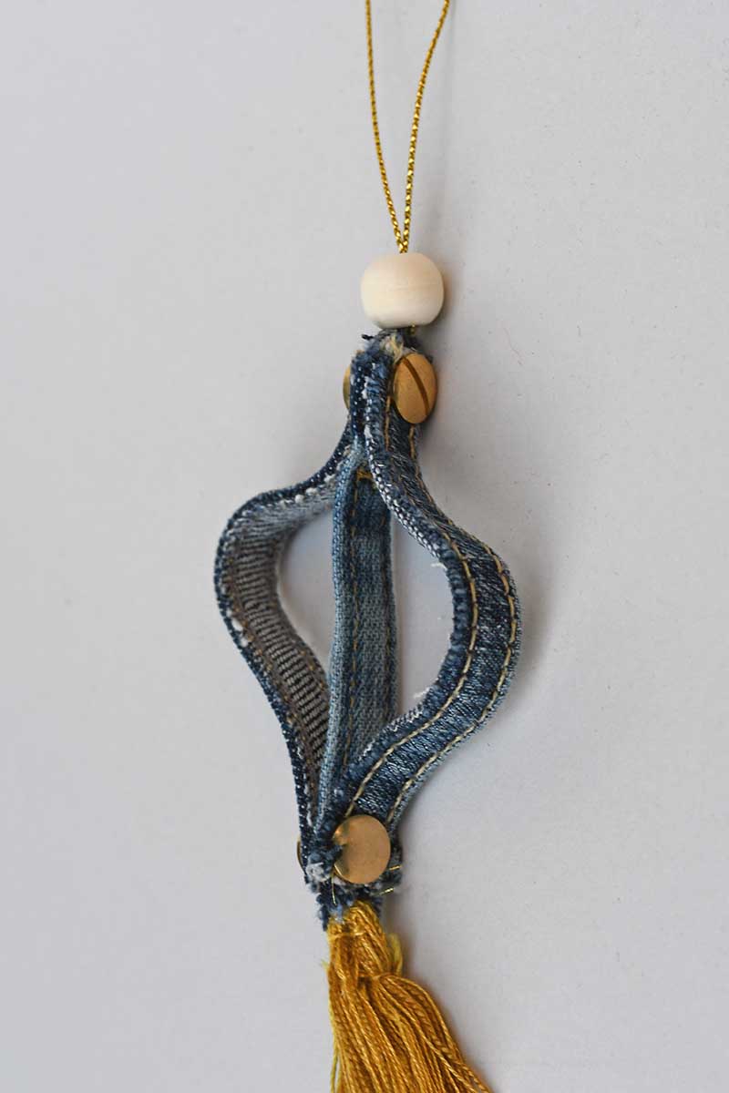 Adding twine for hanging with beads to denim seam ornament