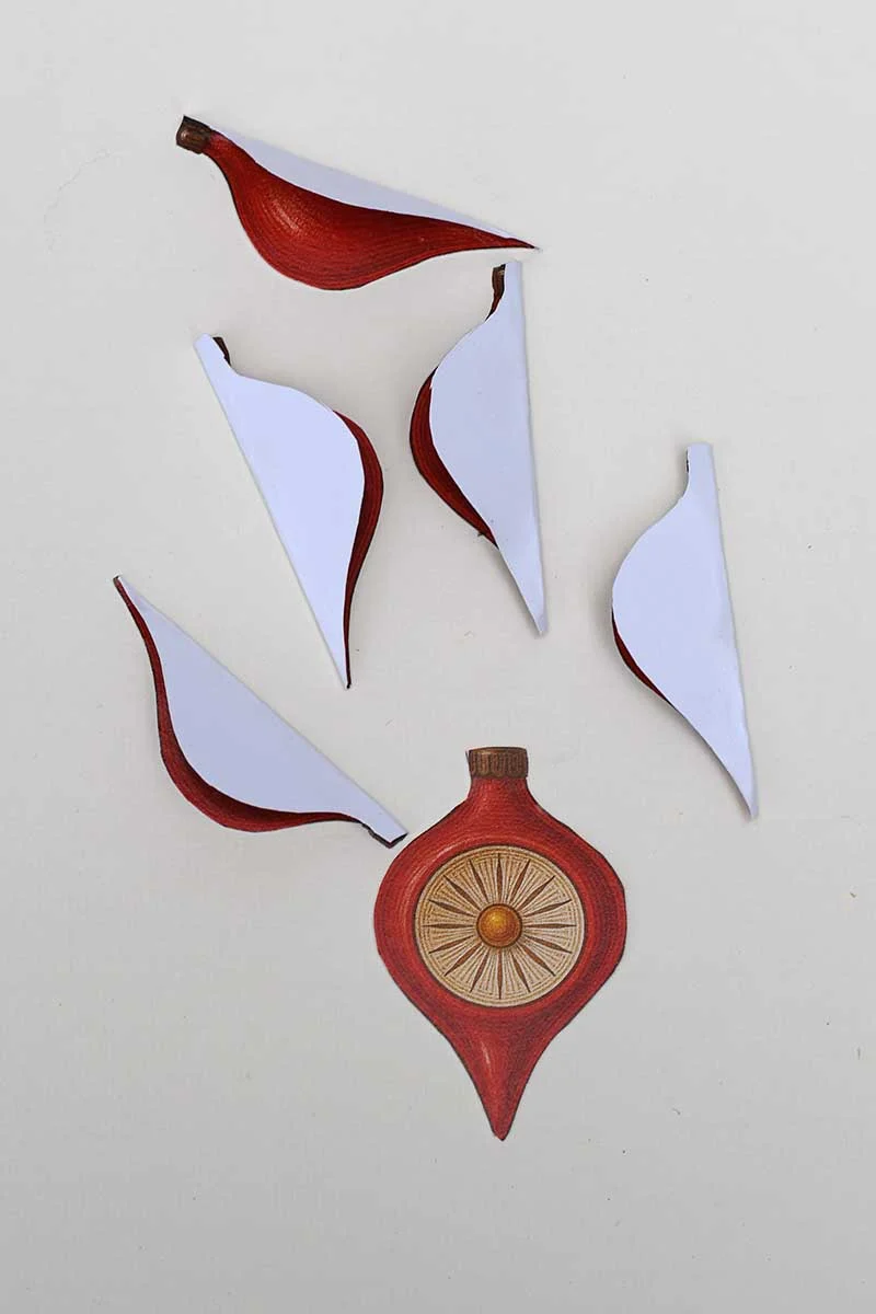 folding the Christmas paper ornament pices in half