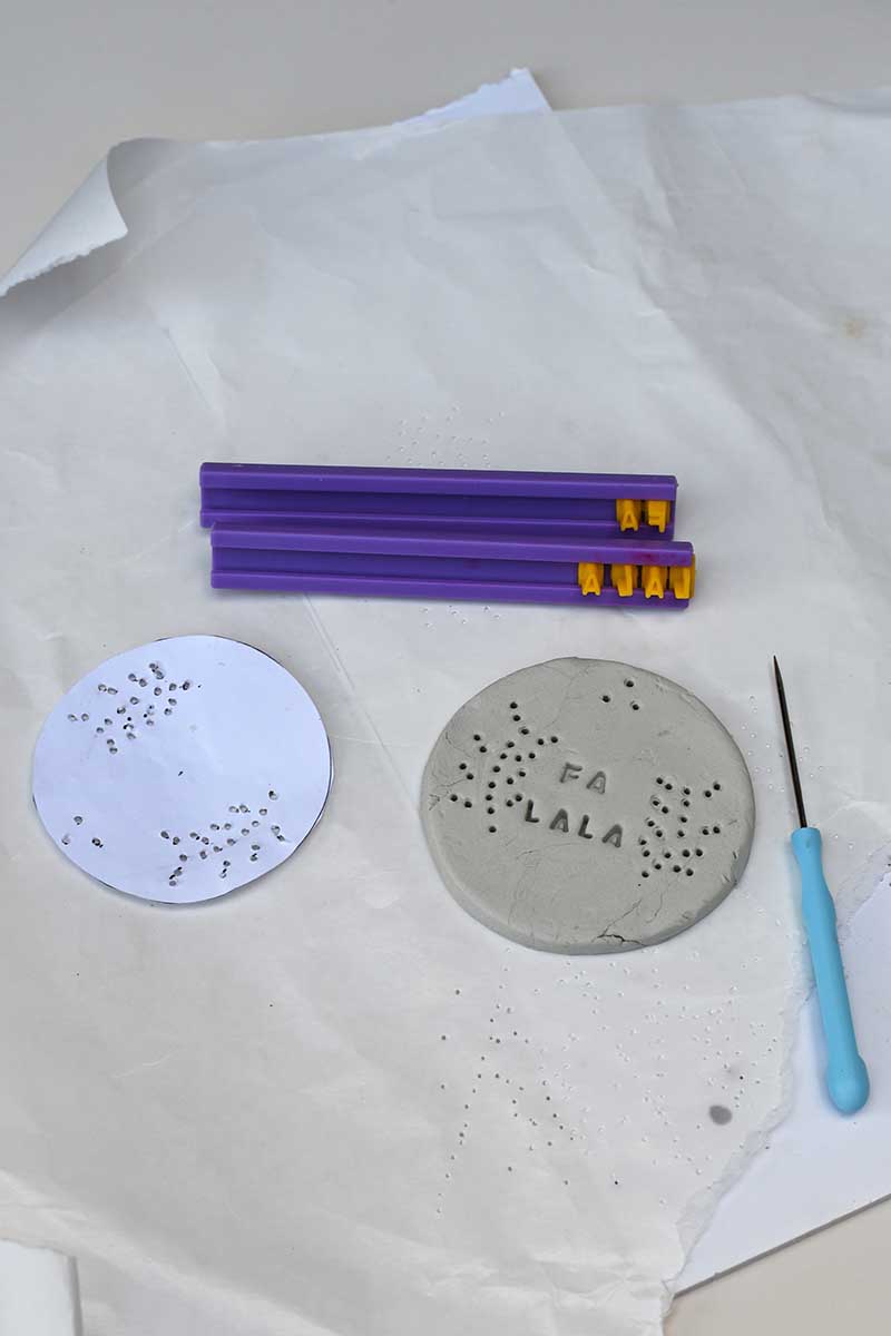 Stamping the bauble ornament clay with letters