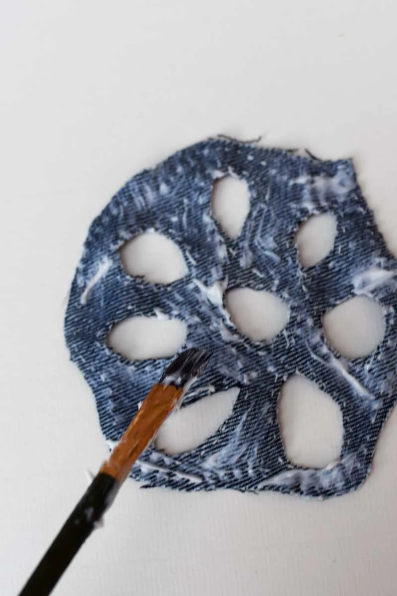 Applying glue to the back of the felt pieces