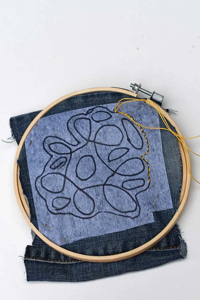 Stitching denim coaster in embroidery hoop