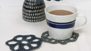 Two denim coasters hand stitched with cup of coffee feature