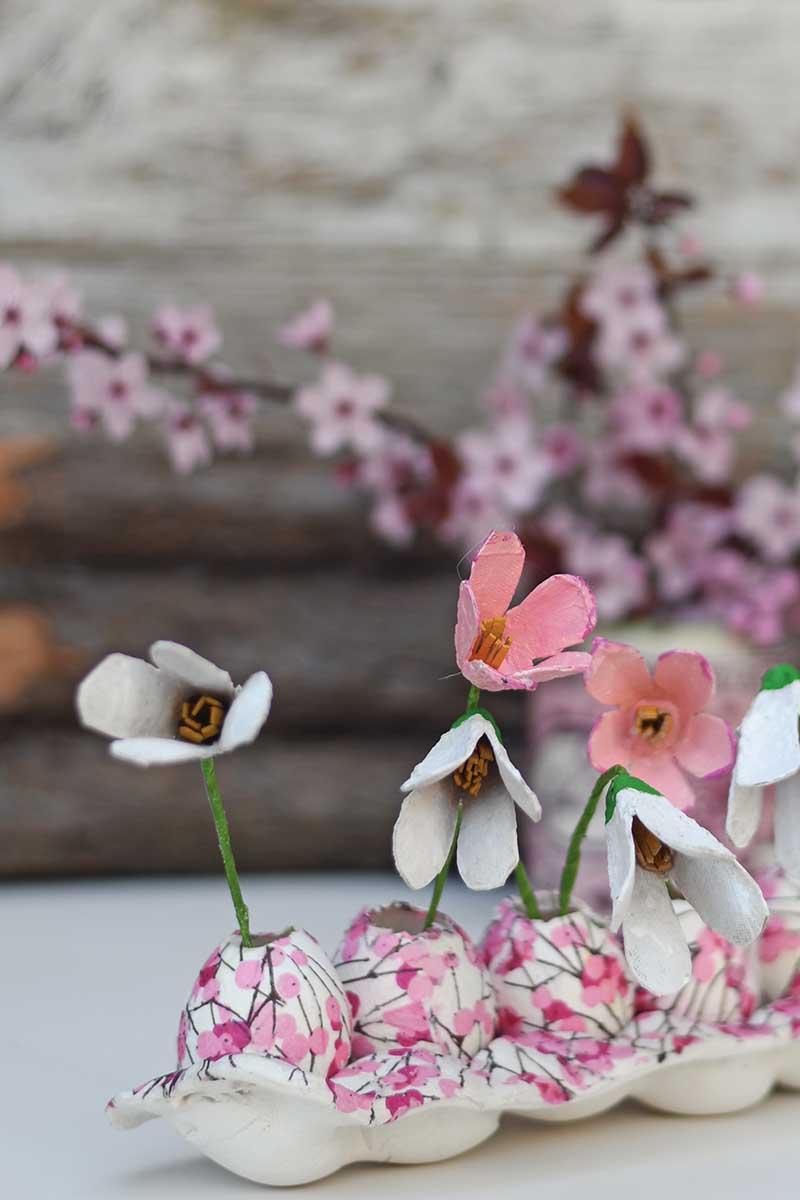 Egg carton spring display decoration of upcycled flowers, egg vases and clay egg tray