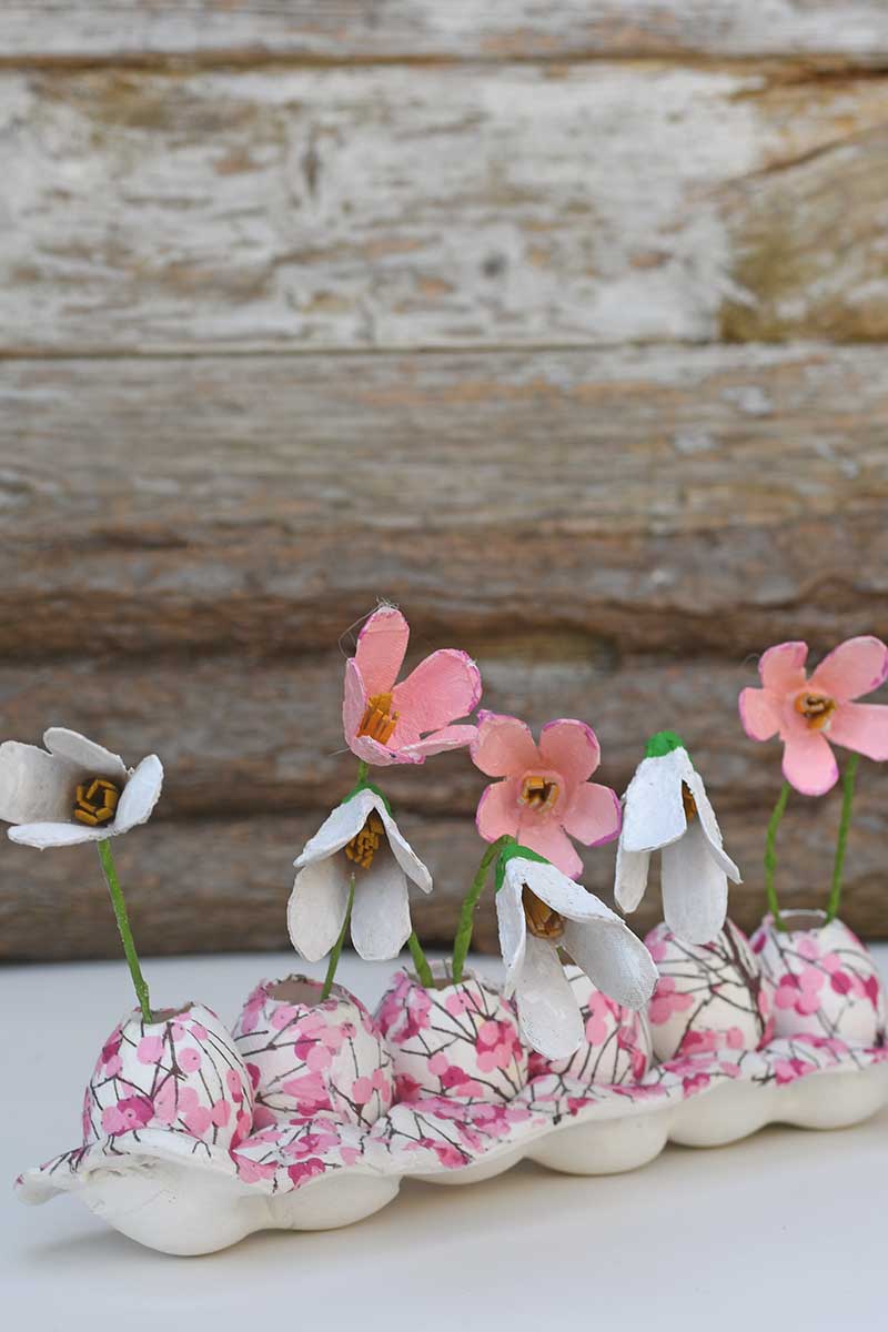 Egg carton spring display decoration of upcycled flowers, egg vases and clay egg tray