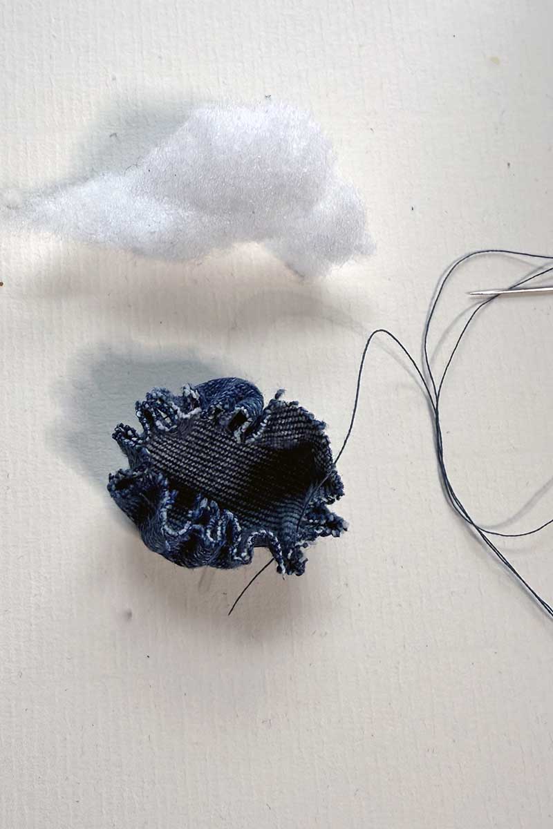 sewing denim yo-yo for centre of upcycled fabric bluebell flower