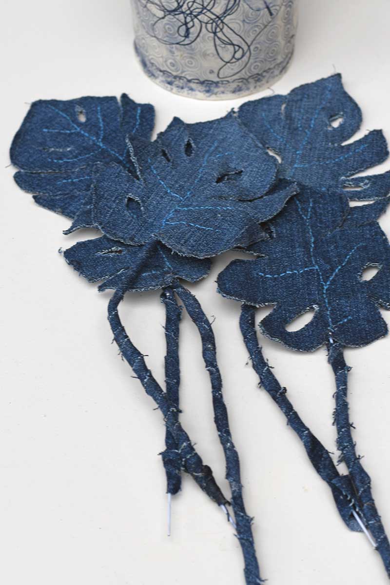 Five denim Monstera leaves