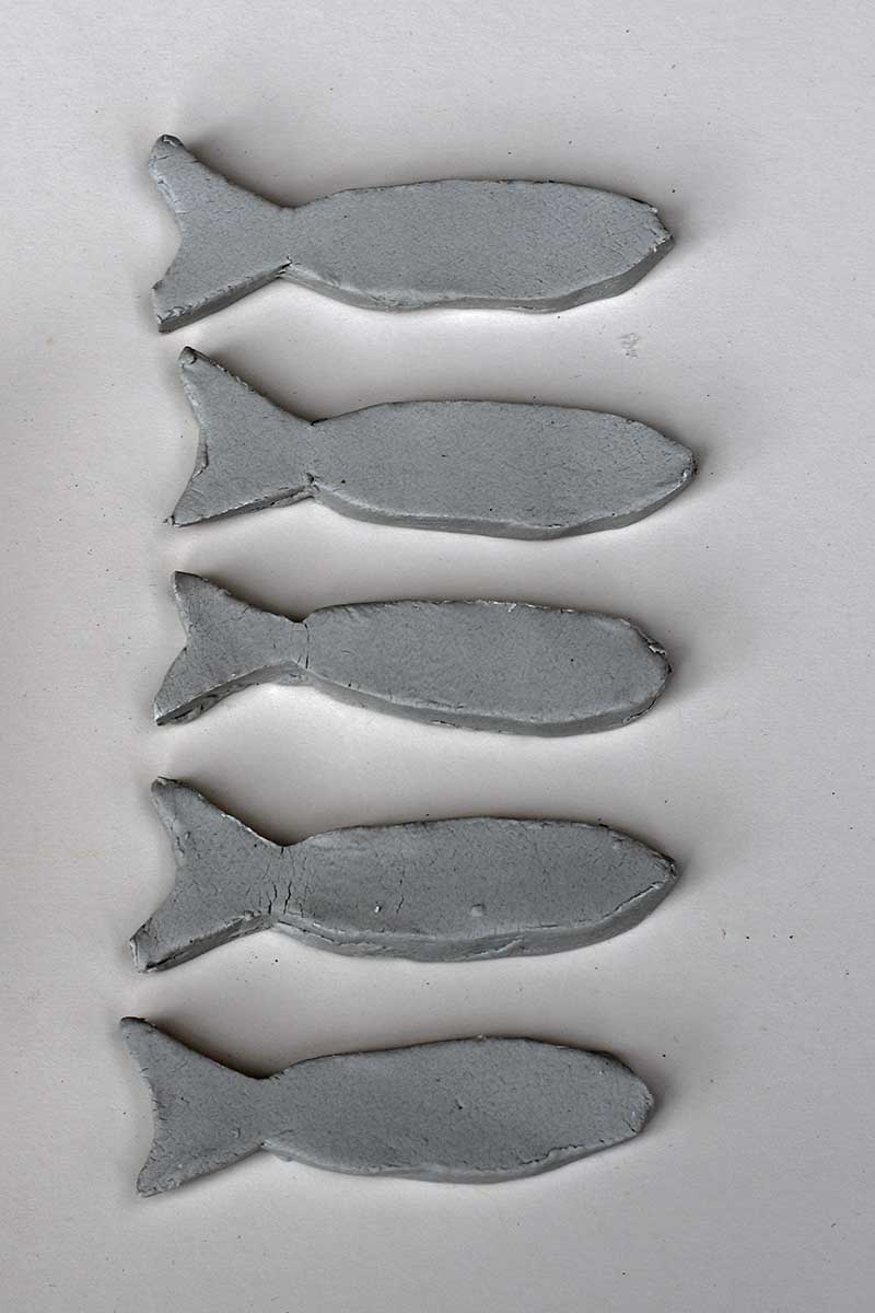 Five cut out clay fish
