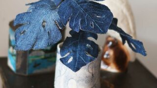 denim Monstera plant with ceramic cockatoo