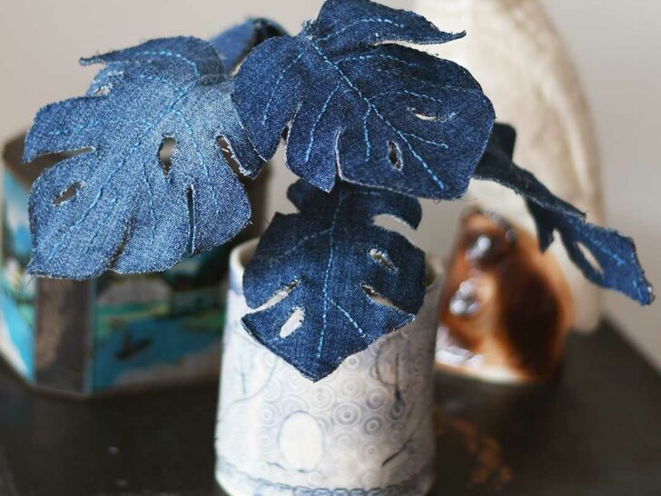 denim Monstera plant with ceramic cockatoo
