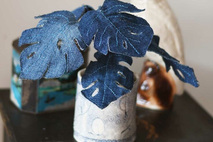 denim Monstera plant with ceramic cockatoo