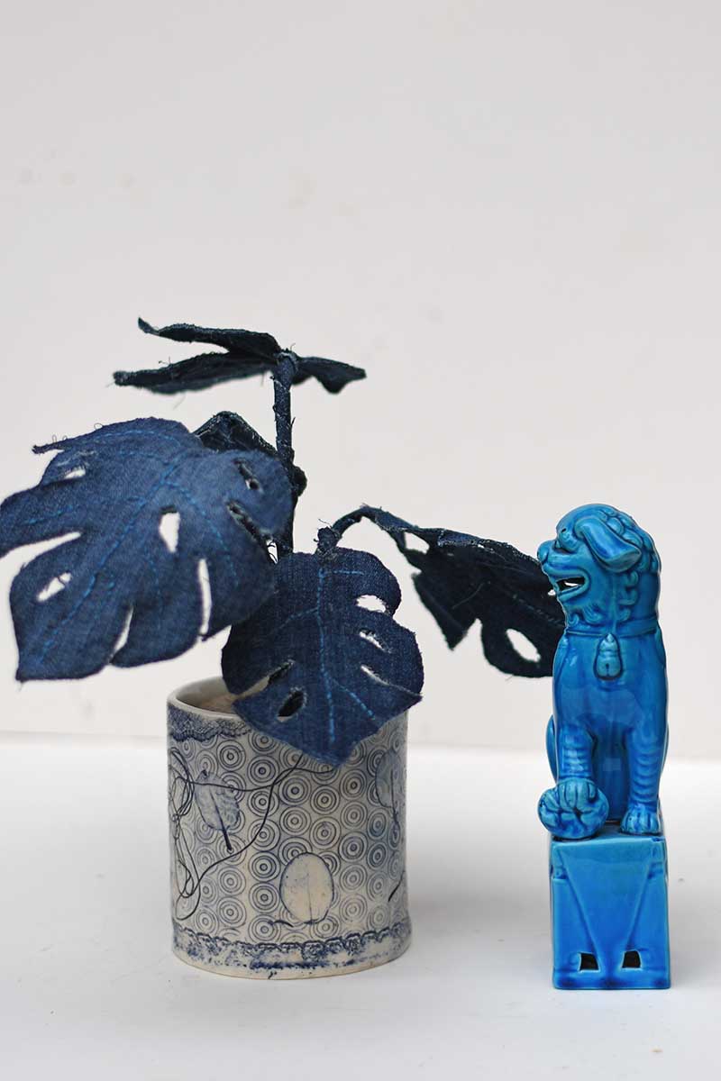 Denim monstera plant with foo dog in blue