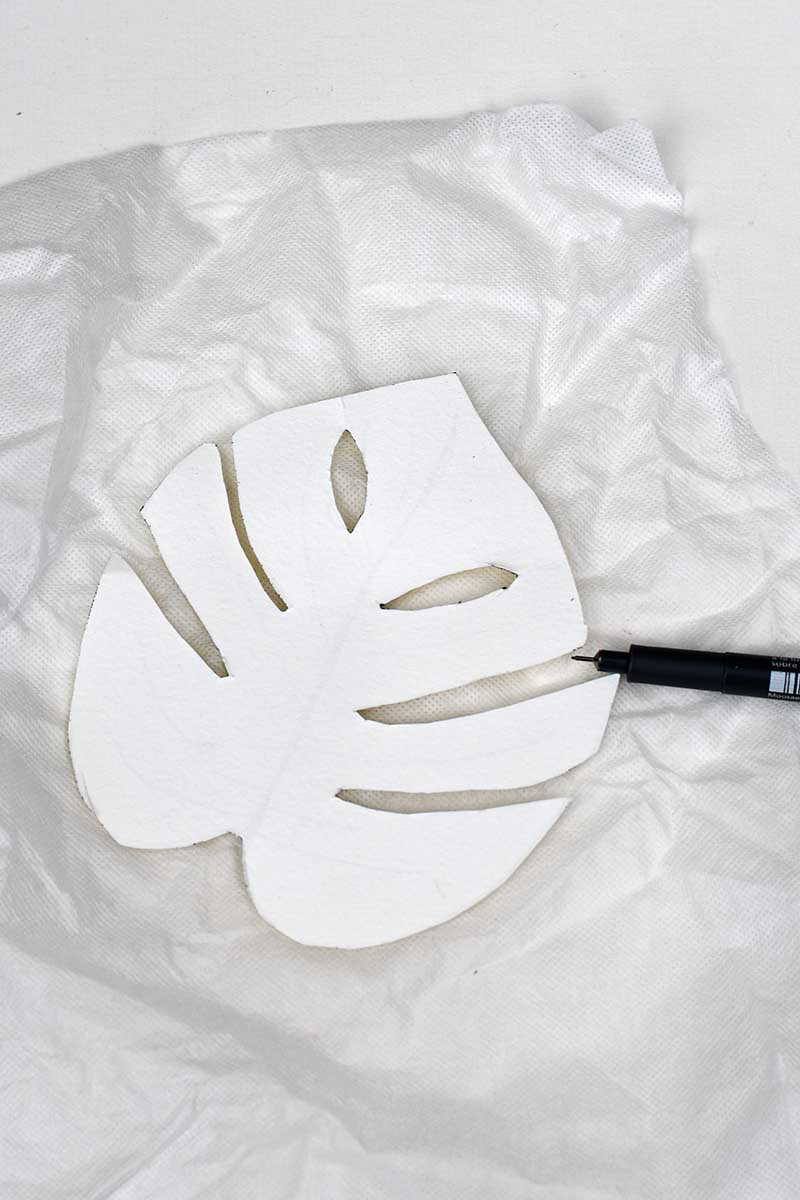 drawing around the Monstera template onto water soluble embroidery paper