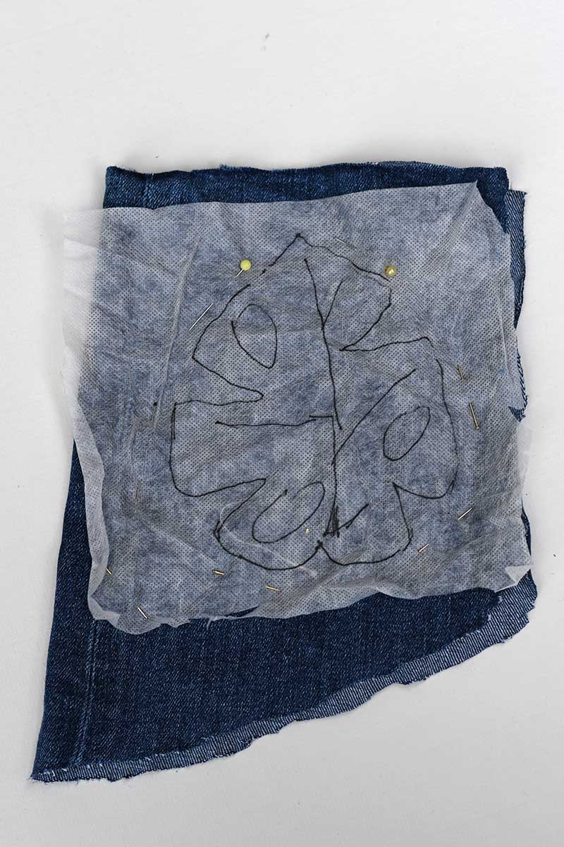 Pattern pinned to denim leg
