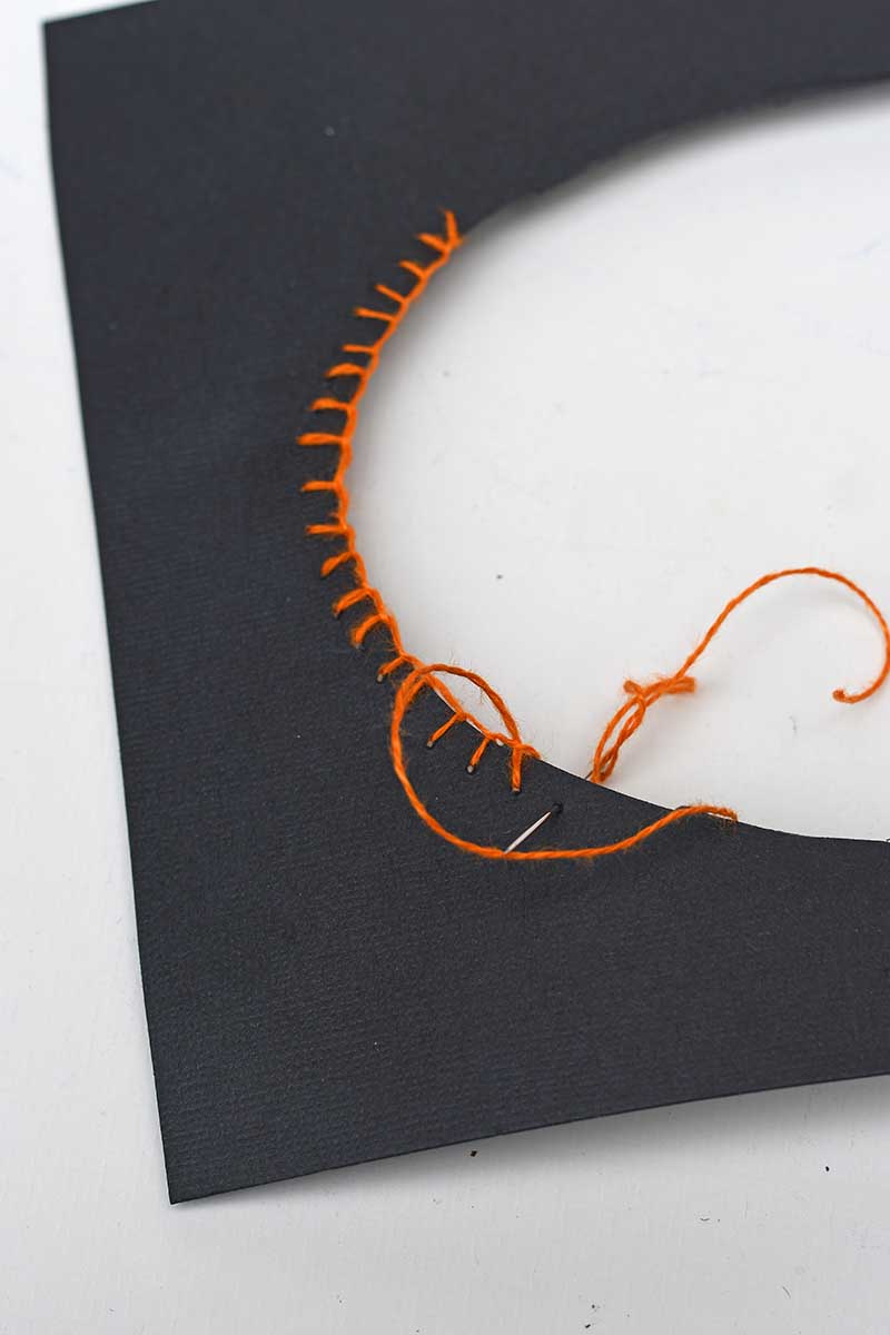 stitching the mount with orange blanket stitch