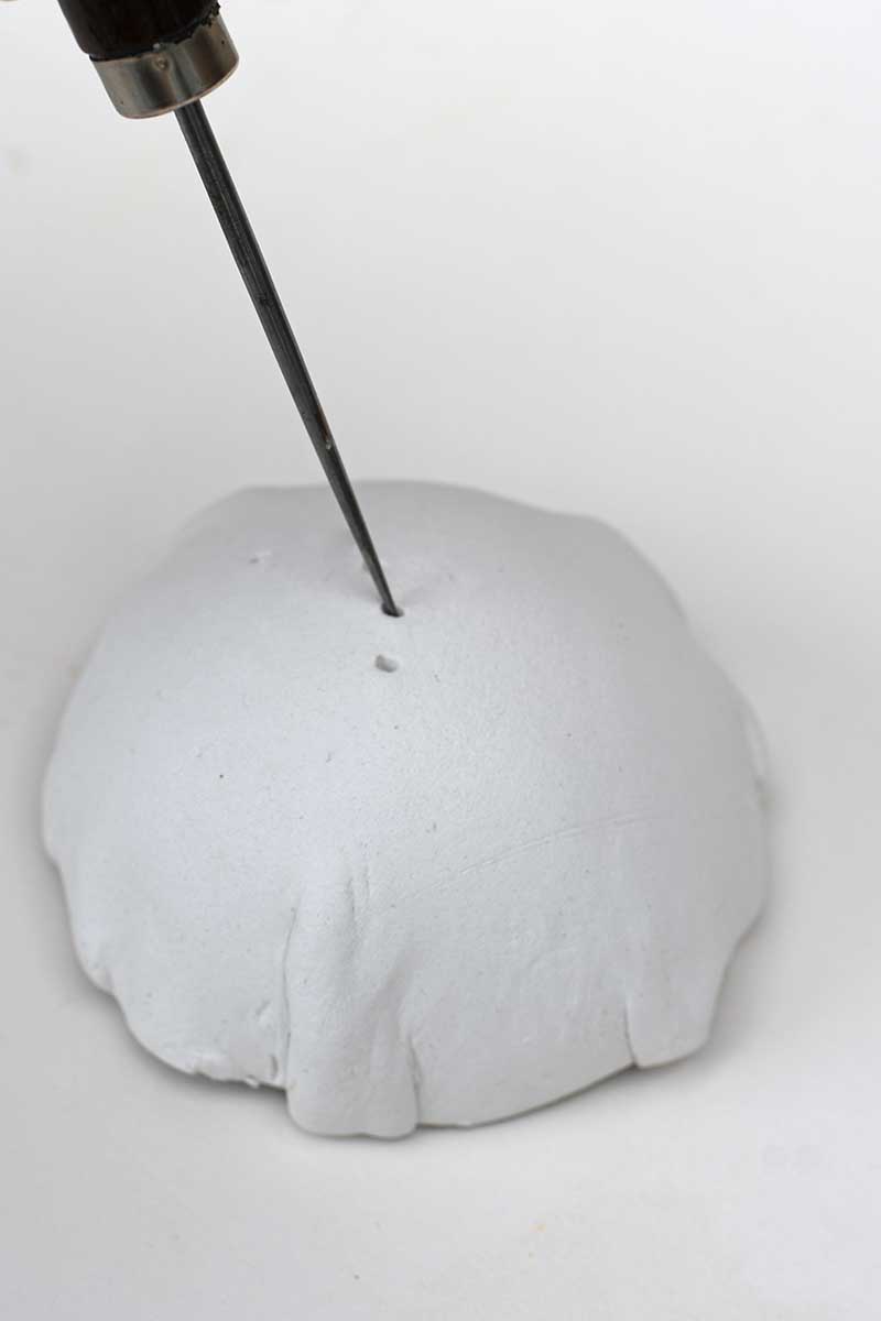 piercing holes into top of air dry clay dome