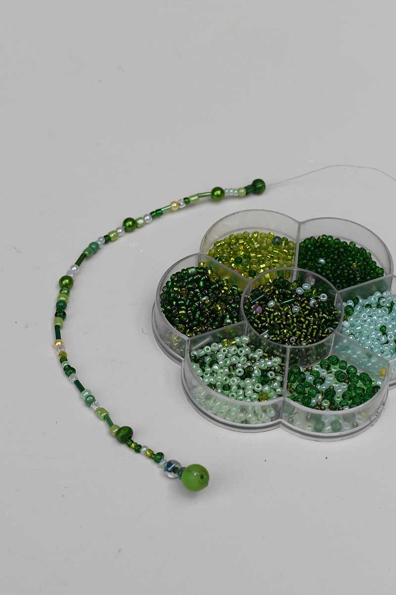 Threading the beads onto wire to make jellyfish tentacles