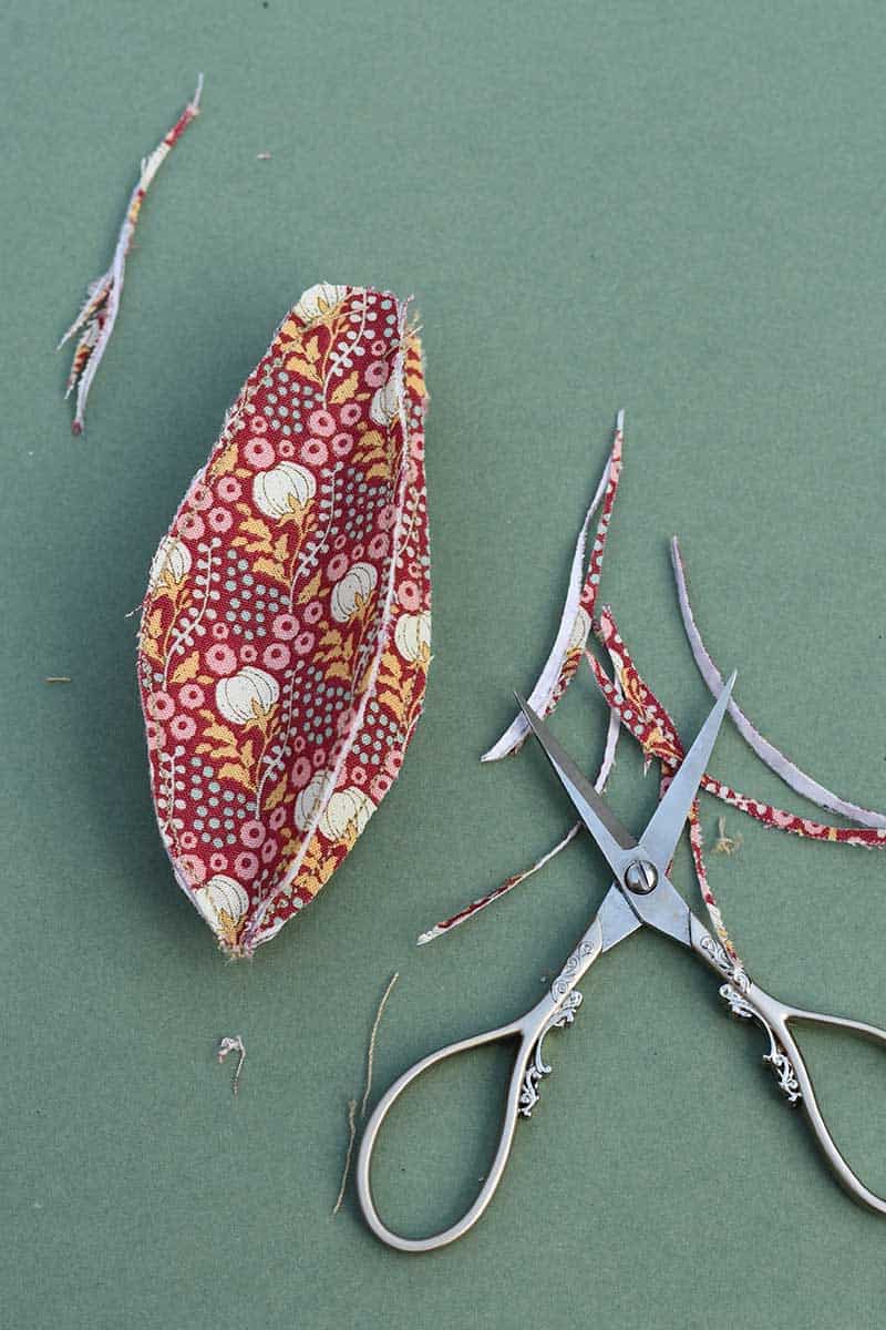 trimming the edges of the fabric seed pods
