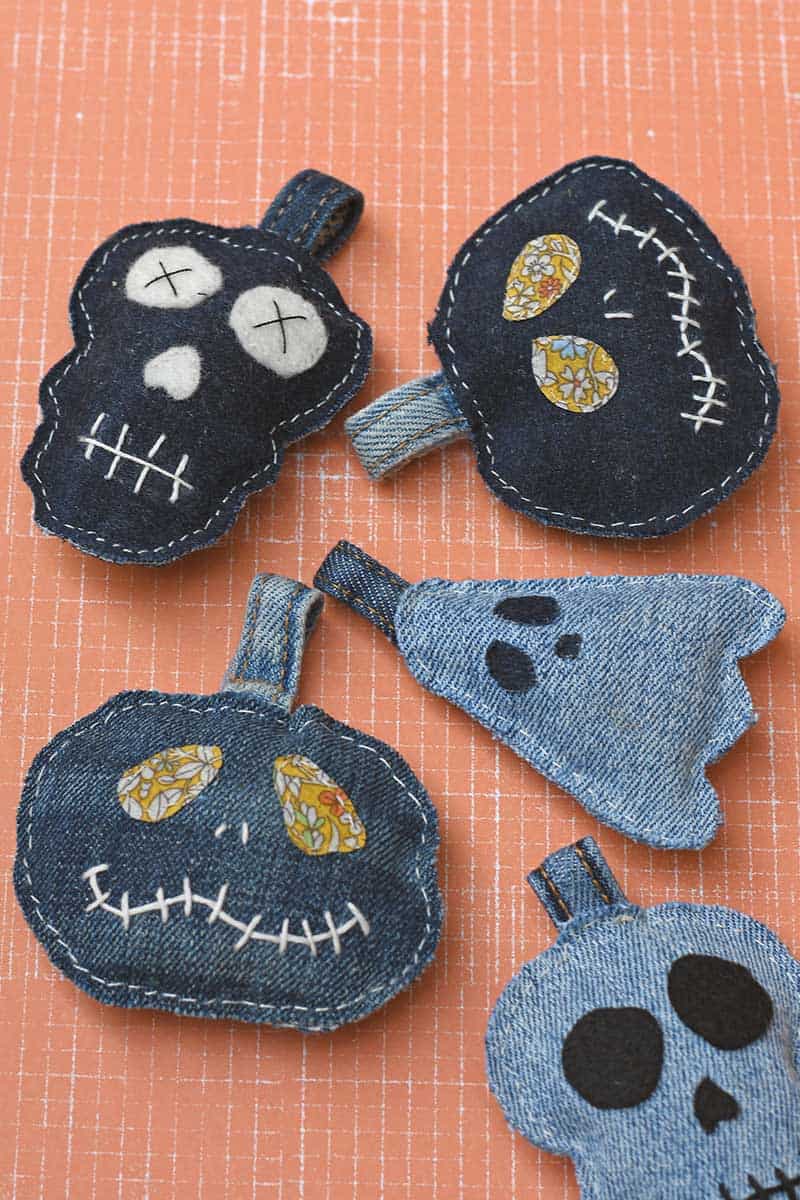 Finished halloween denim keychains on orange background